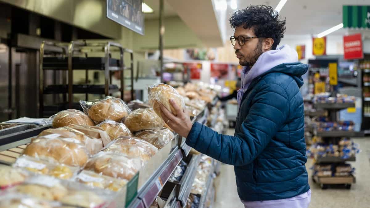 Young Asian man shopping in a supermarket